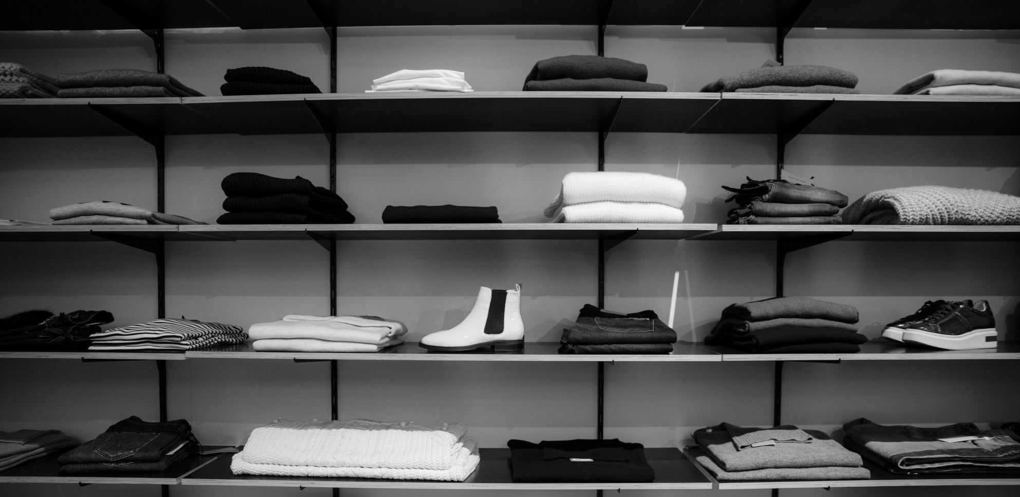 Black and white image of clothing racks